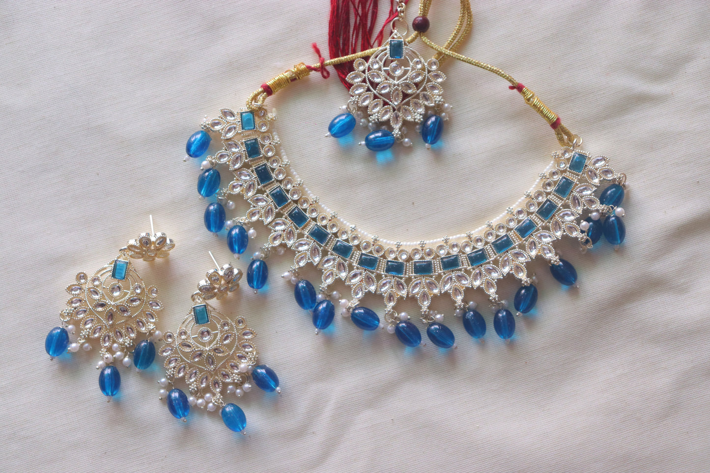 Necklace with Blue studded stones along with tiara and earrings